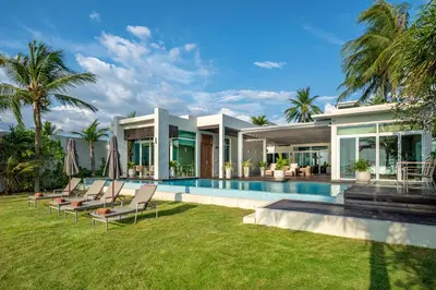 a house with a swimming pool next to a house at Aleenta Phuket - Phang Nga - The Leading Hotels of the World in Natai Beach