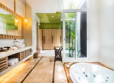 a bathroom with a large tub and a window at Aleenta Phuket - Phang Nga - The Leading Hotels of the World in Natai Beach