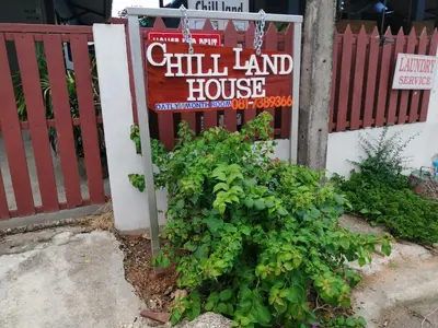 a sign for a hill land house next to a fence at Chill land house in Bang Tao Beach