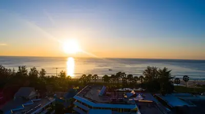 a sunset over the ocean from a resort at Woraburi Phuket Resort & Spa - SHA Plus in Karon Beach