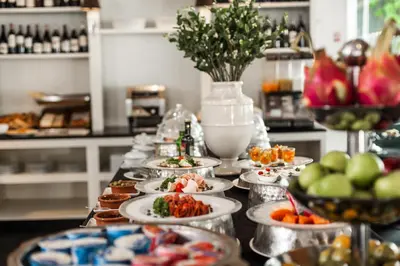 a buffet with plates of food on a table at BYD Lofts - Boutique Hotel & Serviced Apartments - Patong Beach, Phuket in Patong Beach