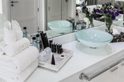 a bathroom counter with a sink and a mirror at BYD Lofts - Boutique Hotel & Serviced Apartments - Patong Beach, Phuket in Patong Beach