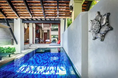 a swimming pool in the middle of a house at The Slate, Phuket in Nai Yang Beach