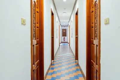 a corridor of an empty hallway with wooden doors at Lamai Hotel in Patong Beach