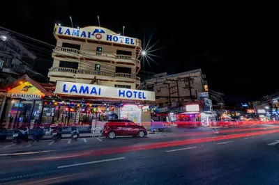 a busy city street at night with a hotel at Lamai Hotel in Patong Beach