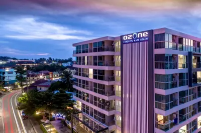 an apartment building with a sign on top of it at Ozone Condotel by RESAVA in Kata Beach