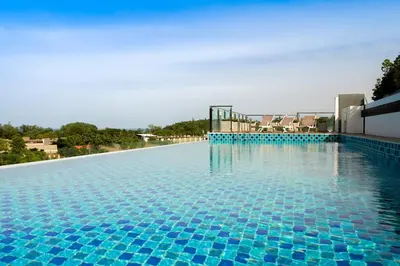 a large swimming pool with blue tiles on it at Ozone Condotel by RESAVA in Kata Beach