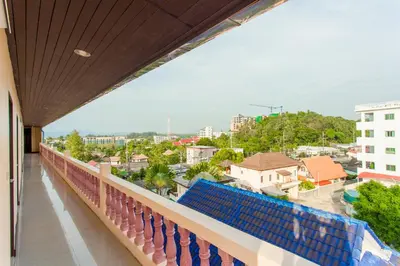 a balcony with a view of a city at Surin Sunset Hotel - SHA in Surin Beach