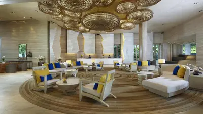 a lobby with couches and chairs and a large ceiling at Amari Phuket in Patong Beach
