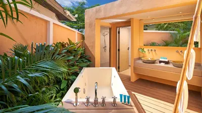 a bathroom with a tub and a sink on a deck at Amari Vogue Krabi in Tab Kaek Beach