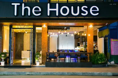 a restaurant with a table and chairs in the house at The House Patong in Patong Beach