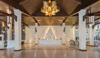 a large hall with a large wall with a chandelier at Diamond Cliff Resort & Spa, Patong Beach in Patong Beach