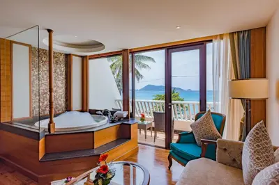 a living room with a tub and a balcony at Diamond Cliff Resort & Spa, Patong Beach in Patong Beach