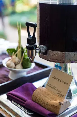 a table with a lamp and a plate of vegetables at Pakasai Resort in Ao Nang Beach