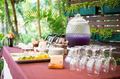 a table with wine glasses and plates of food at Pakasai Resort in Ao Nang Beach