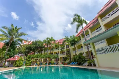 a swimming pool in front of a hotel at MW Krabi Beach Resort - Ao Nang - SHA Extra Plus in Ao Nang Beach