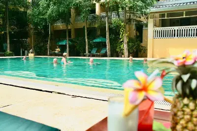 a group of people swimming in a swimming pool at MW Krabi Beach Resort - Ao Nang - SHA Extra Plus in Ao Nang Beach