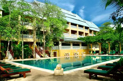 a swimming pool in front of a building at MW Krabi Beach Resort - Ao Nang - SHA Extra Plus in Ao Nang Beach