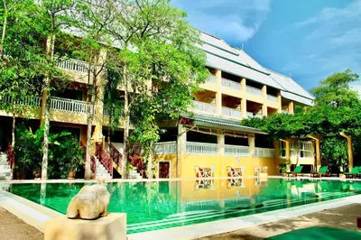 a hotel with a swimming pool in front of a building at MW Krabi Beach Resort - Ao Nang - SHA Extra Plus in Ao Nang Beach