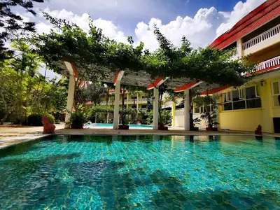 a swimming pool in front of a building at MW Krabi Beach Resort - Ao Nang - SHA Extra Plus in Ao Nang Beach