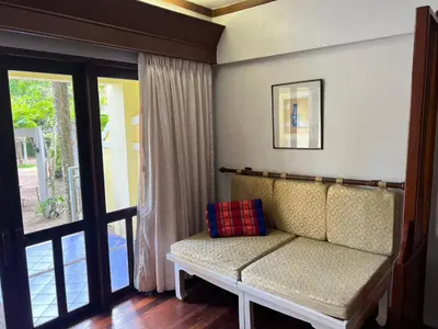 a living room with a couch and a window at MW Krabi Beach Resort - Ao Nang - SHA Extra Plus in Ao Nang Beach