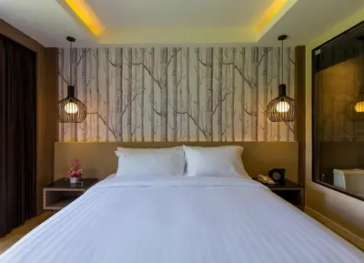 a bedroom with a large white bed and two lamps at GLOW Ao Nang Krabi in Ao Nang Beach