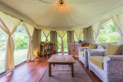 a living room with a couch and a table at 9 Hornbills Tented Camp in Ko Yao Noi