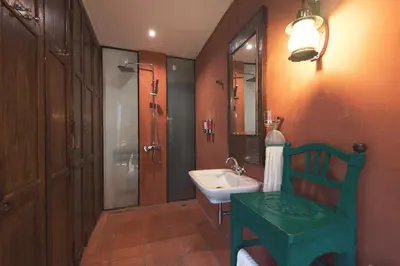 a bathroom with a sink and a toilet and a mirror at 2ROOMS Boutique House in Phuket Town