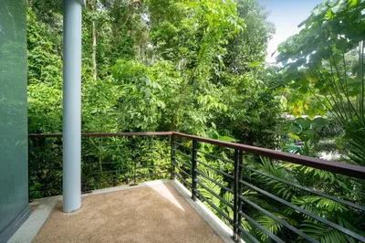 a balcony with a view of the forest at Kamala Sea View-villa with private pool and maid in Kamala Beach