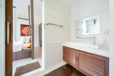 a bathroom with a sink and a mirror at Kamala Sea View-villa with private pool and maid in Kamala Beach