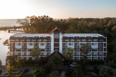 an aerial view of a hotel with the ocean in the background at The Hotspring Beach Resort & Spa - SHA Extra Plus in Natai Beach