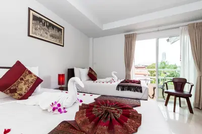 a hotel room with two beds with a swan on the floor at Silver Resortel in Patong Beach