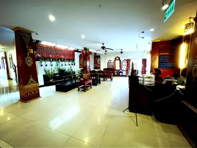 a lobby of a store with tables and chairs at Silver Resortel in Patong Beach