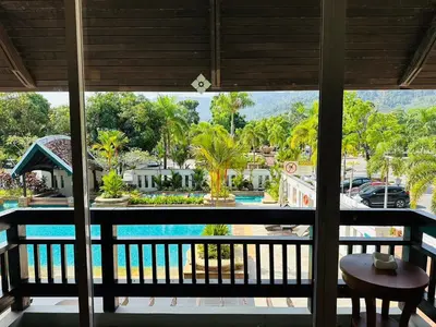 a view of the pool from the balcony of a resort at Mission Hills Phuket Golf Resort-SHA Extra Plus in Por Bay