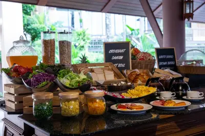 a buffet with vegetables and other foods on a table at Chanalai Garden Resort, Kata Beach in Kata Beach