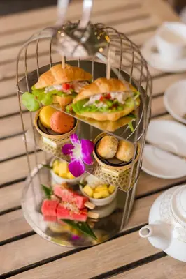 a plate with sandwiches and other food on a table at Ma Doo Bua Stay - SHA Extra Plus in Thalang