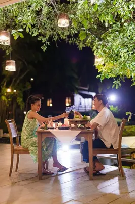 a man and a woman sitting at a table at Ma Doo Bua Stay - SHA Extra Plus in Thalang