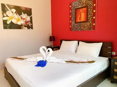 a bedroom with a bed with a towel on it at MA MAISON BOUTIQUE HOTEL. in PHUKET in Bang Tao Beach