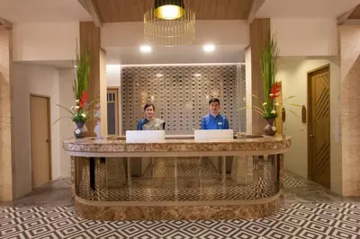 two people standing at a large table in a lobby at Access Resort & Villas - SHA Plus in Karon Beach