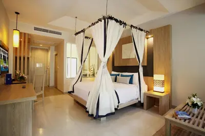 a bedroom with a bed with a canopy at Access Resort & Villas - SHA Plus in Karon Beach