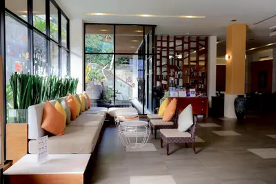 a lobby with a couch and chairs in a store at Peach Blossom Resort & Pool Villa - SHA Plus in Kata Beach
