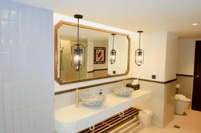 a bathroom with two sinks and a mirror at Peach Hill Resort - SHA Extra Plus in Kata Beach