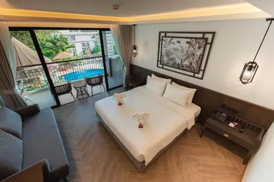 a bedroom with a bed with two teddy bears on it at Peach Hill Resort - SHA Extra Plus in Kata Beach
