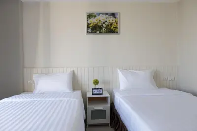 two beds sitting next to each other in a room at The Royal P Phuket - SHA Plus in Phuket Town