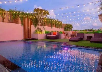 a swimming pool with a string of lights over it at The Royal P Phuket - SHA Plus in Phuket Town