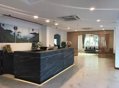 a lobby with a reception desk in a building at The Royal P Phuket - SHA Plus in Phuket Town