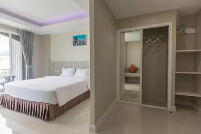 a bedroom with a bed and a walk in closet at The Royal P Phuket - SHA Plus in Phuket Town