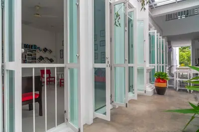 a hallway of a house with glass doors at The Old Phuket - Karon Beach Resort in Karon Beach
