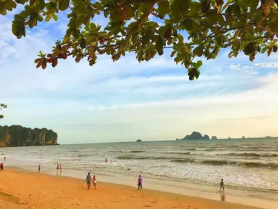 a group of people walking on the beach at The Sea Condo Cozy Private Room at Ao nang Krabi in Ao Nang Beach