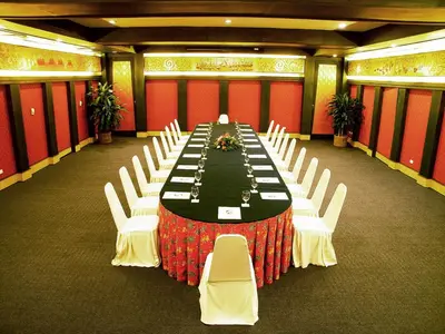 a long dining room with a long table and white chairs at Andaman Seaview, Karon Beach - SHA Plus in Karon Beach
